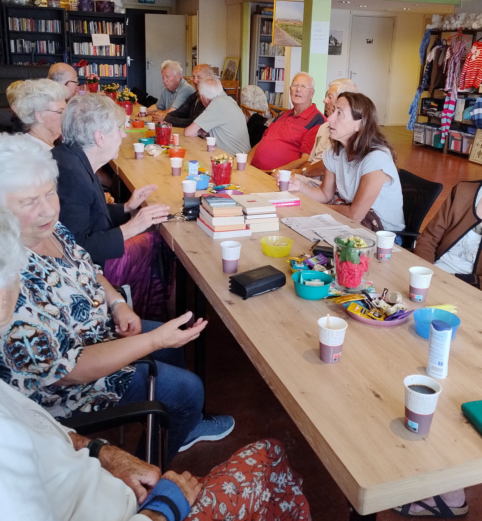 Bezoekers aan tafel tijdens een inloopochtend van het DOP